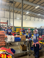 The Cheesecake Factory staff members from Roseville, CA volunteer at a Give Back program event at their local food bank