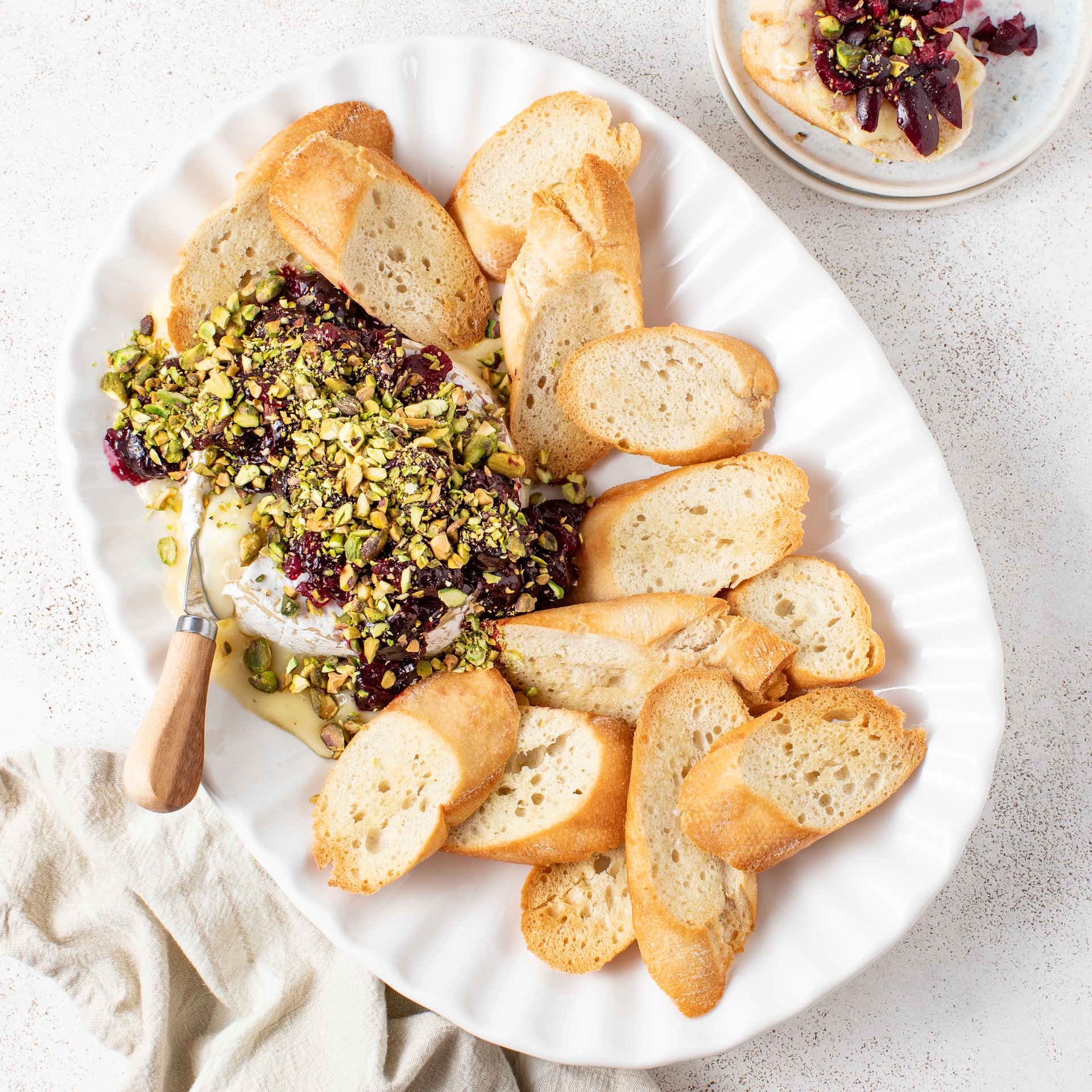 Baked Brie with Fresh Cardamom-Cherry Compote, Pistachios & Toasted Baguette